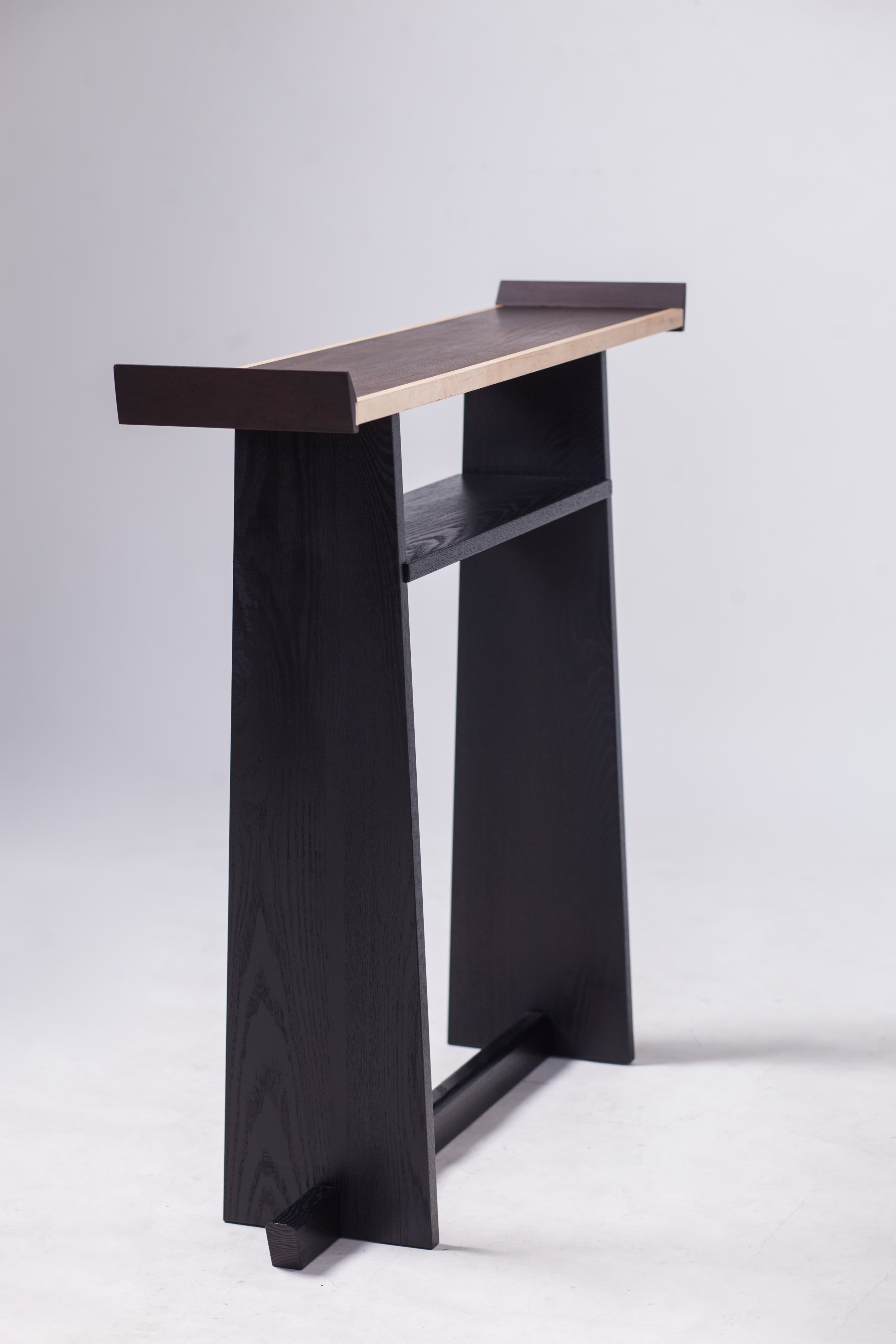 Three-quarter view of Product 01 showing its narrow top and open frame.
