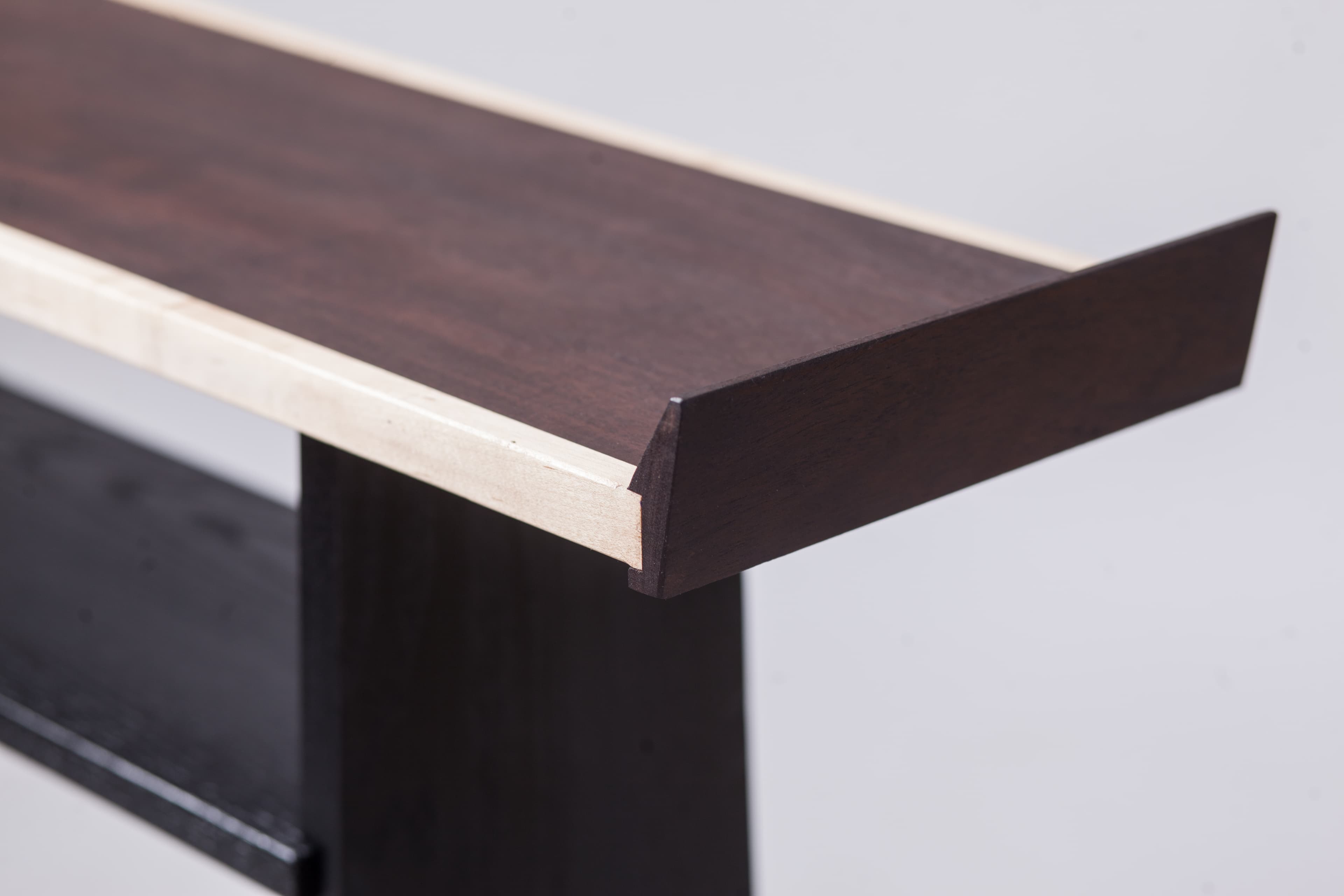Close view of Product 01's raised end and contrasting top edge.