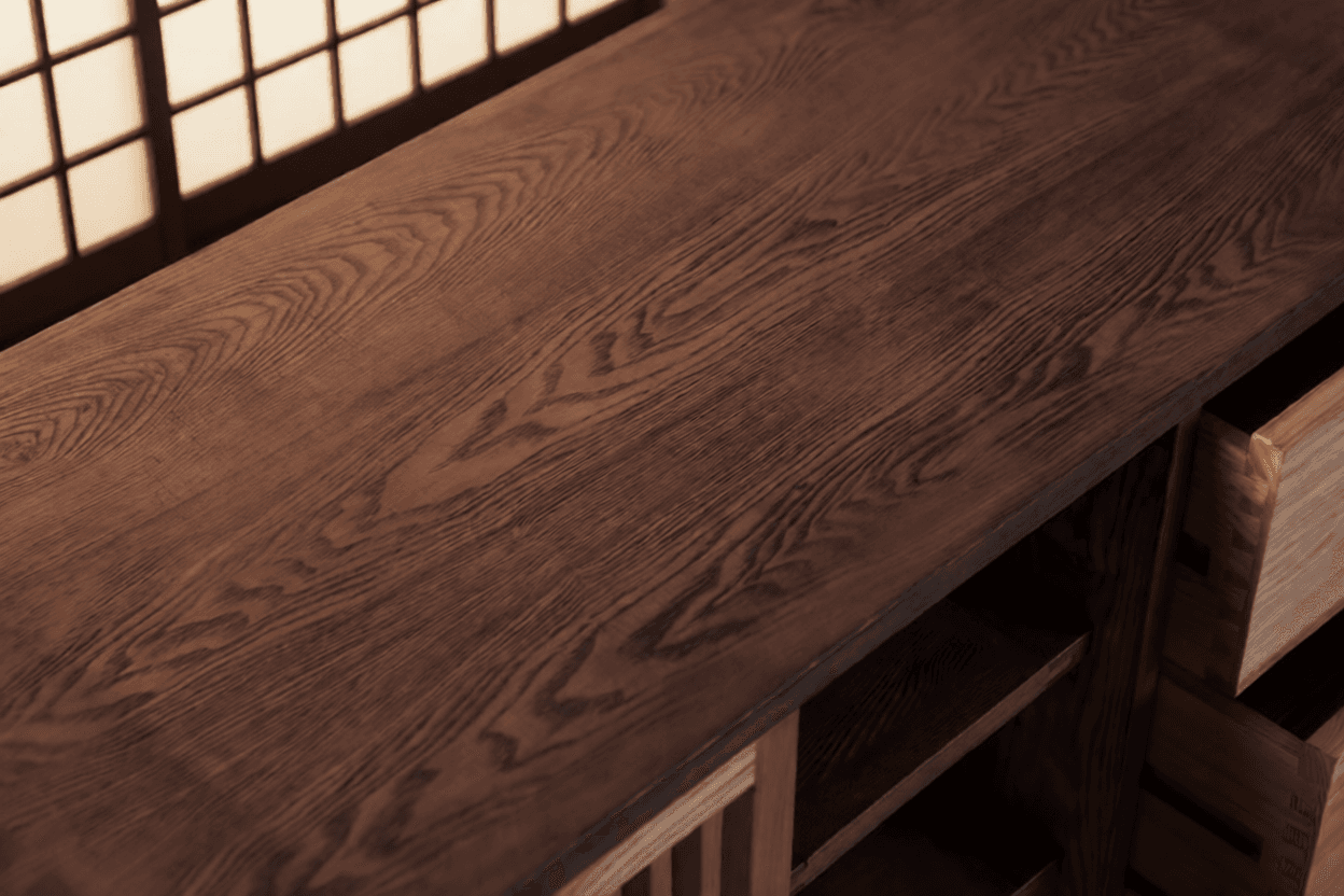 Close view of Product 02's dark wooden top and open drawer joinery.