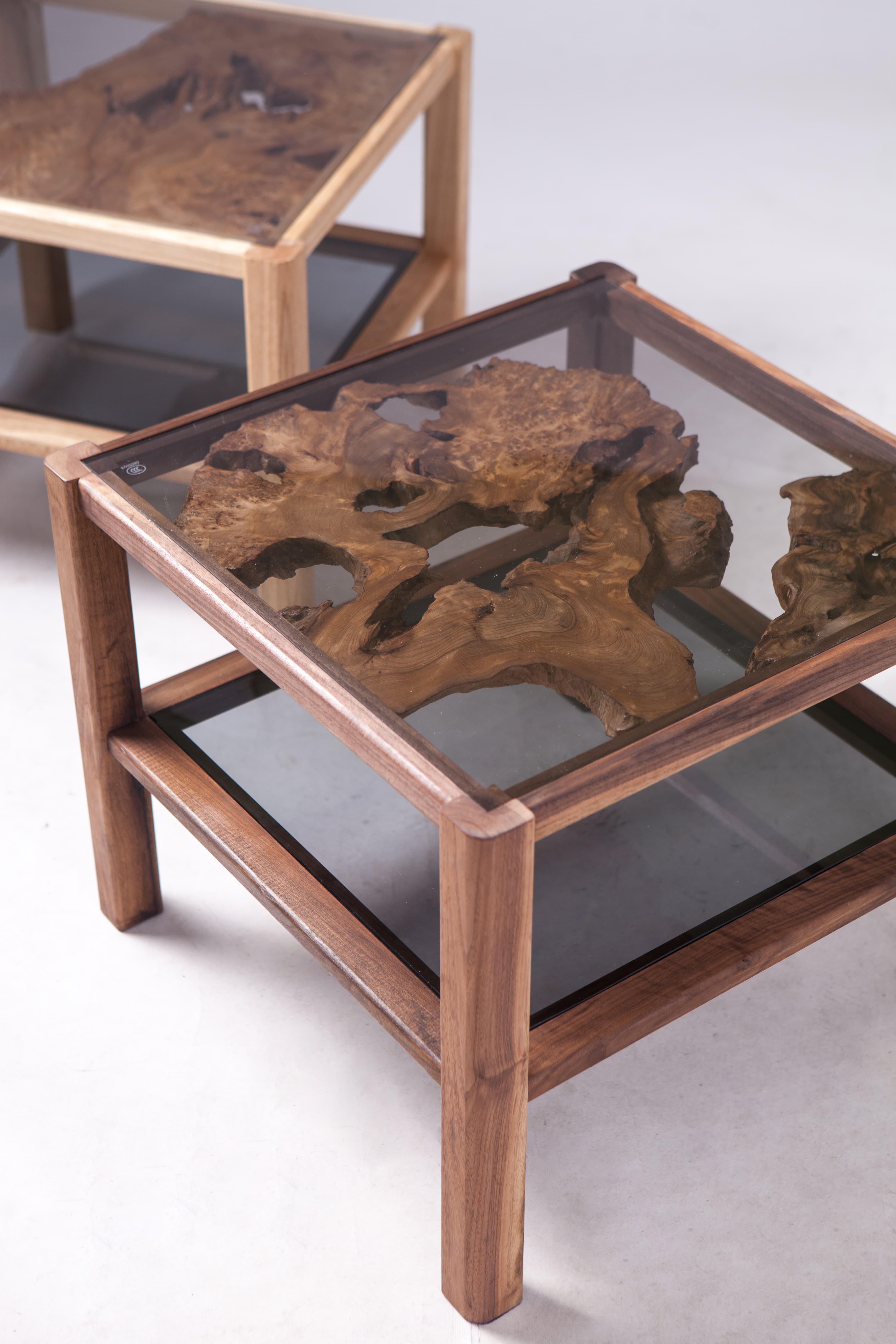 Close three-quarter view of Product 03's glass top and wooden frame.
